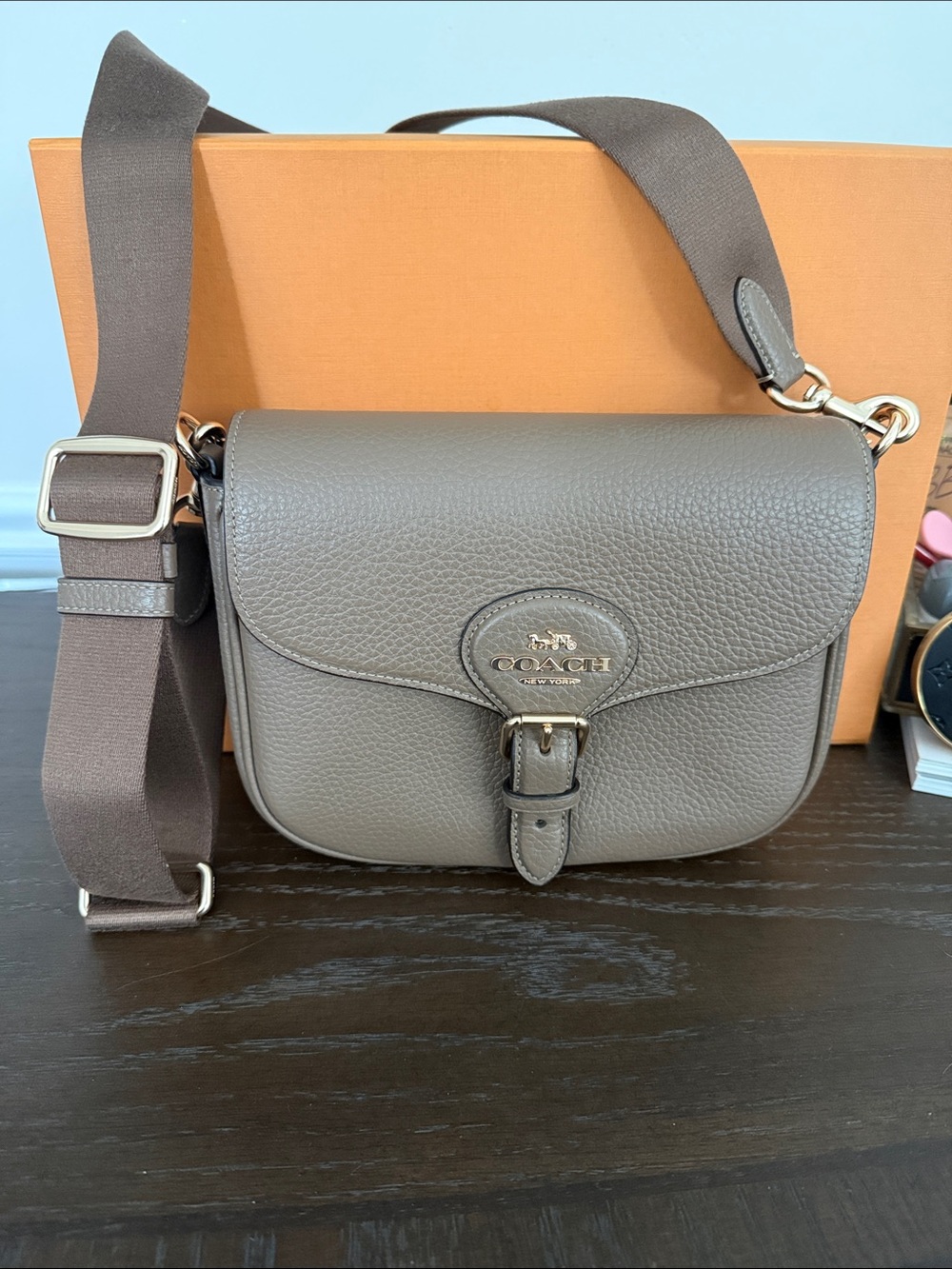 Coach Pebbled Amelia saddle Leather Crossbody Bag in dark stone color.